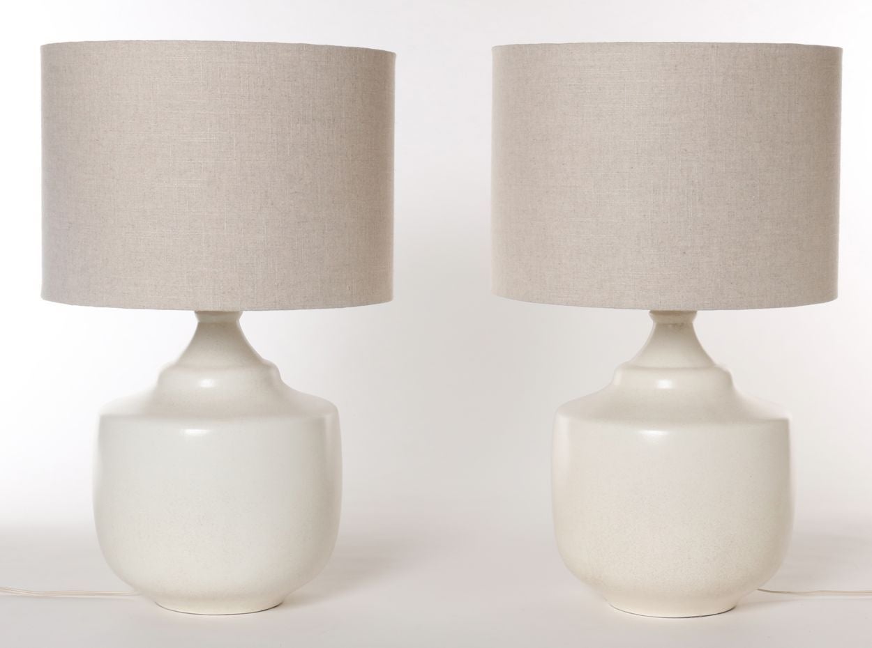Matching ceramic lamps in a creamy stone-white glaze, sold complete with custom-made linen shades. A unique pair of Lotte Lamps by Gunnar & Lotte Bostlund.

Shade measurement:
Diameter: 17