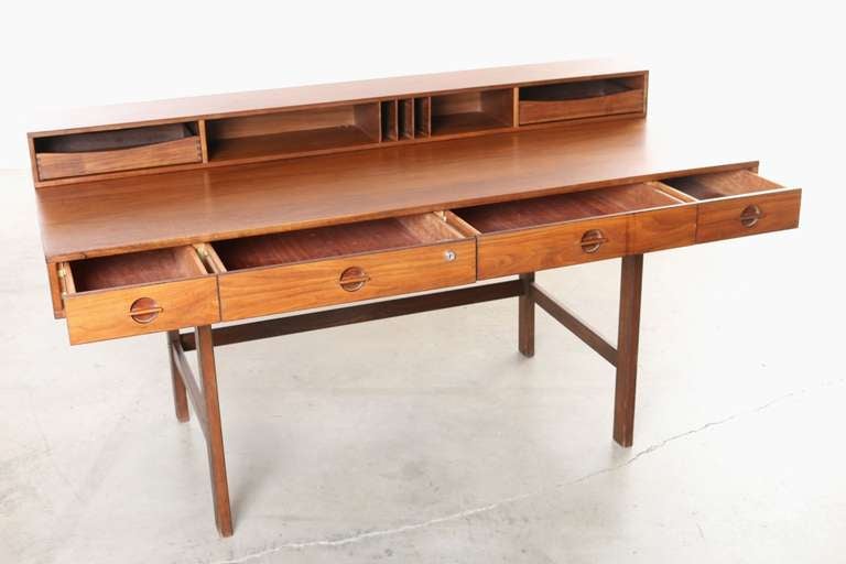 This amazing versatile flip top / partners desk was designed by Jens Quistgaard in 1967 for Lovig Furniture Denmark.
The desk surface flips back to creating a larger work surface or partners desk.  There is a secretary section with two tray drawers