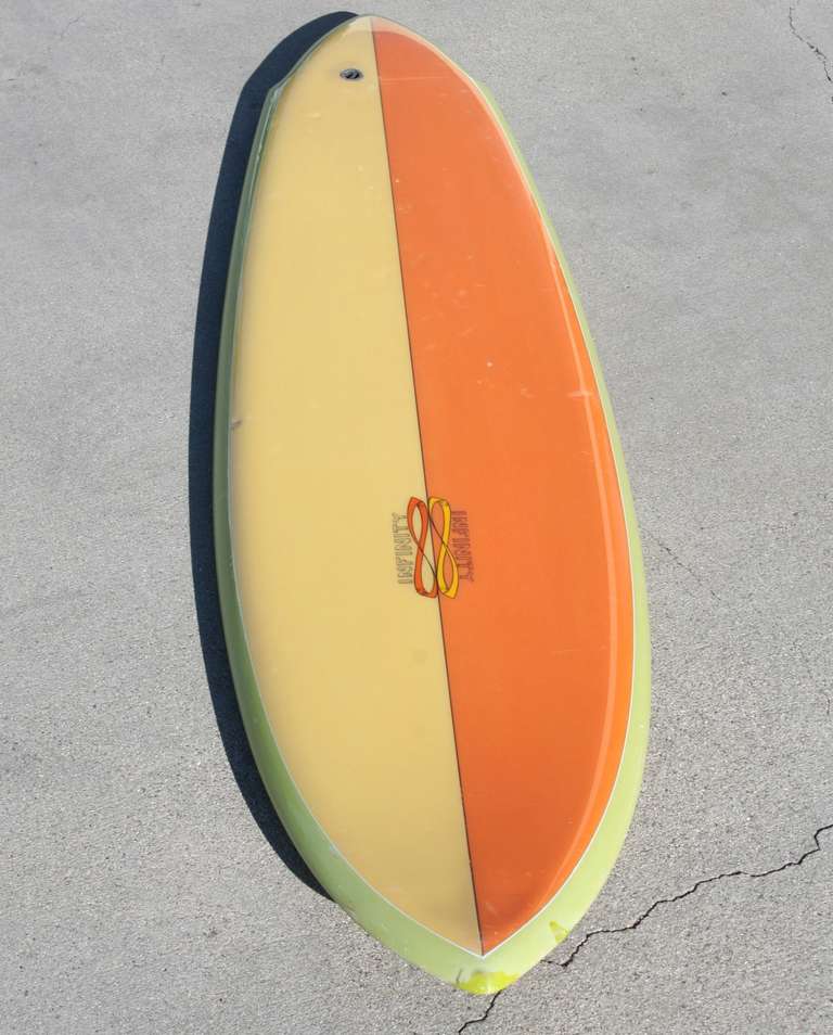 This classic thruster is perfectly sized for an area where a big surf impact is desired.. but not a lot of space is available. Vibrant original colors: half orange and half yellow deck with a lime green bottom and rail... reminds us of a great