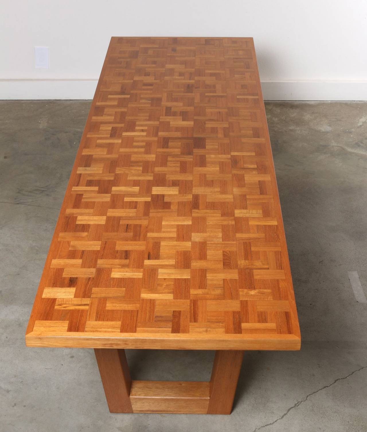 Eye-catching, unique and beautifully crafted 8 foot long artisan made table features expert workmanship, a timeless California design aesthetic and quality materials. The golden oak wood-block tabletop in the style of Mabel Hutchinson is supported
