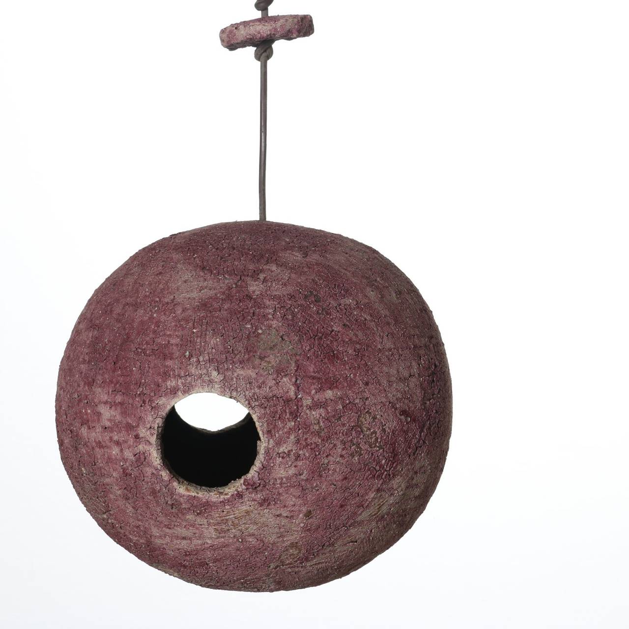 Stan Bitters Bird House, made circa 1970 in an unusual shade of violet - red. This birdhouse has spent its life hanging in a tree. The violet-red matte glaze is now aged and weathered with a solid cherished patina that only nature provides. It makes