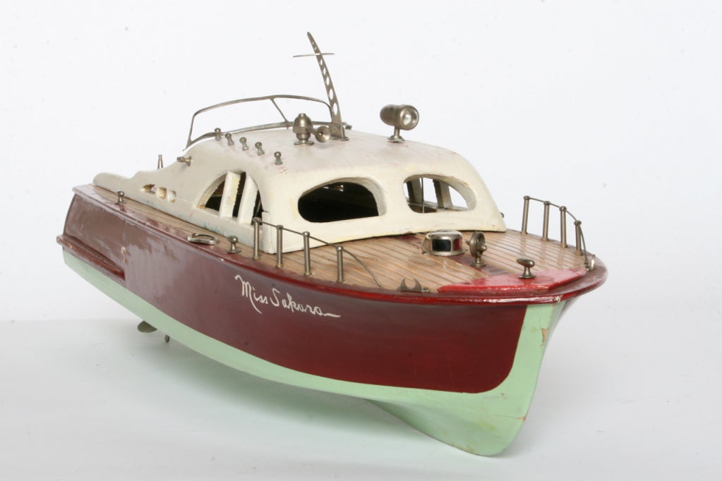 Beautifully hand crafted model cabin cruiser.  Missing a few pieces but absolutely charming.  Think Hemmingway, Bogart and Bacall. Wooden scale model with battery operated motor.  Displays wonderfully.<br />
<br />
Red and Green Hull, Cream Cabin,