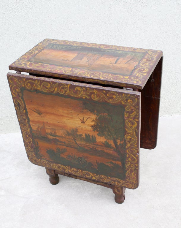 Split gateleg painted dropleaf wooden occasional table late 17th century, William and Mary Style. 
This table was constructed during the late 1600s or early 1700s. It has square drop leaves, paritally turned legs that are split down the center to