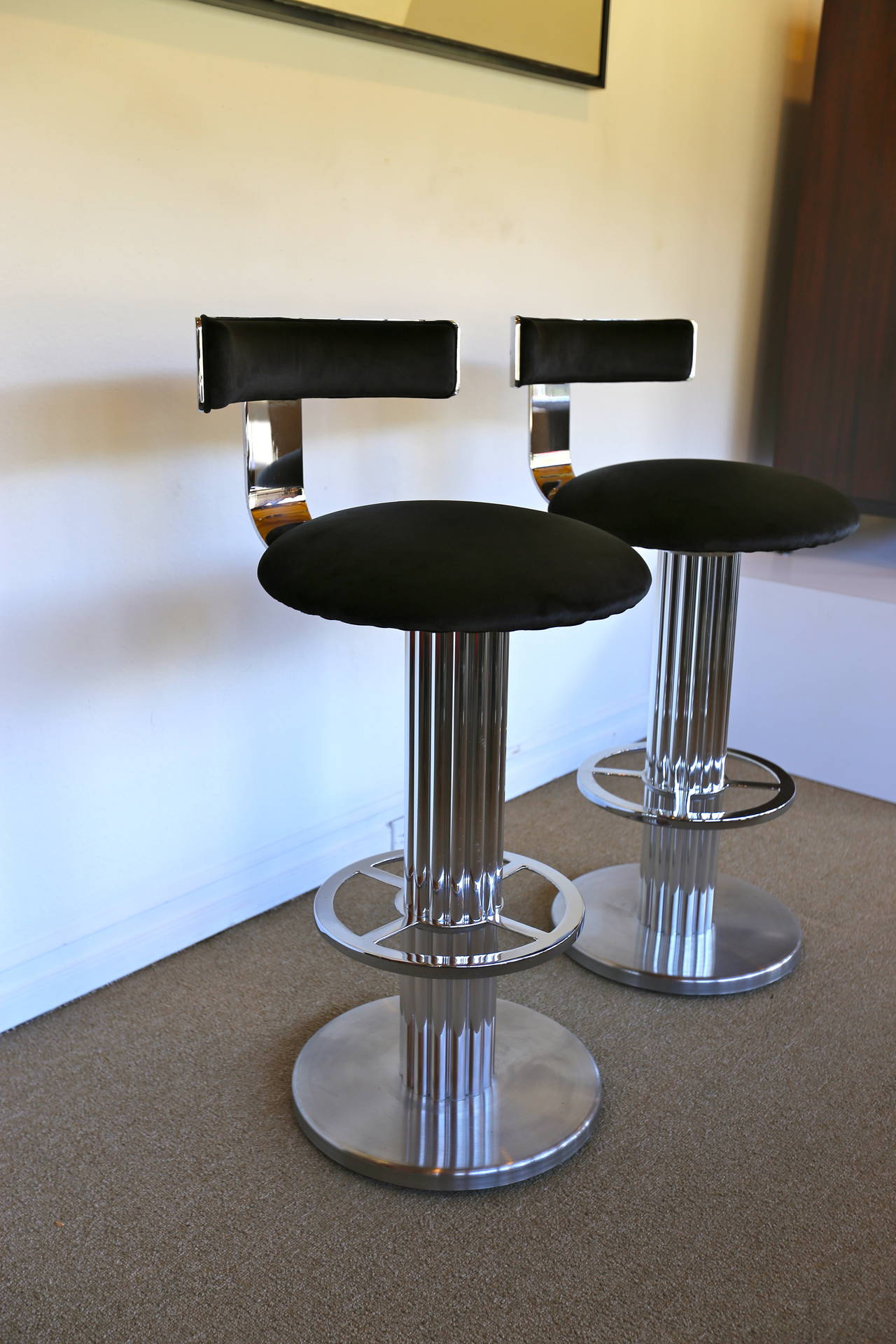 Pair of swivel bar stools by Designs for Leisure.