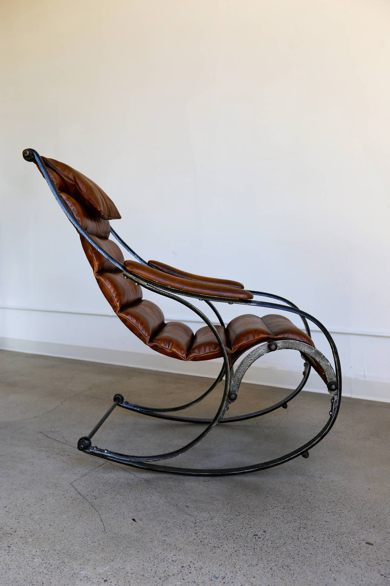 Sculptural leather and steel rocking chair.