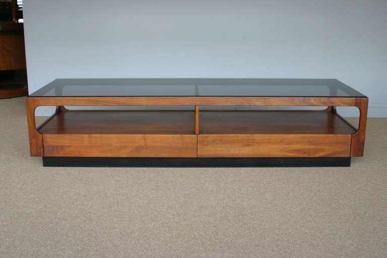 Walnut & smoked glass coffee table by John Keal for Brown Saltman.  Two drawers for storage.  Rich walnut grain. 