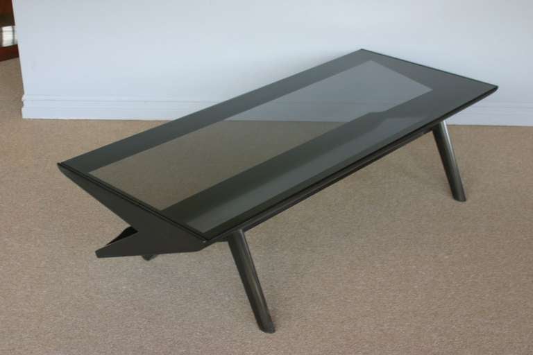 Ebonized & smoked glass coffee table by John Keal for Brown Saltman.  Boomerang shape with magazine rack / shelf. 