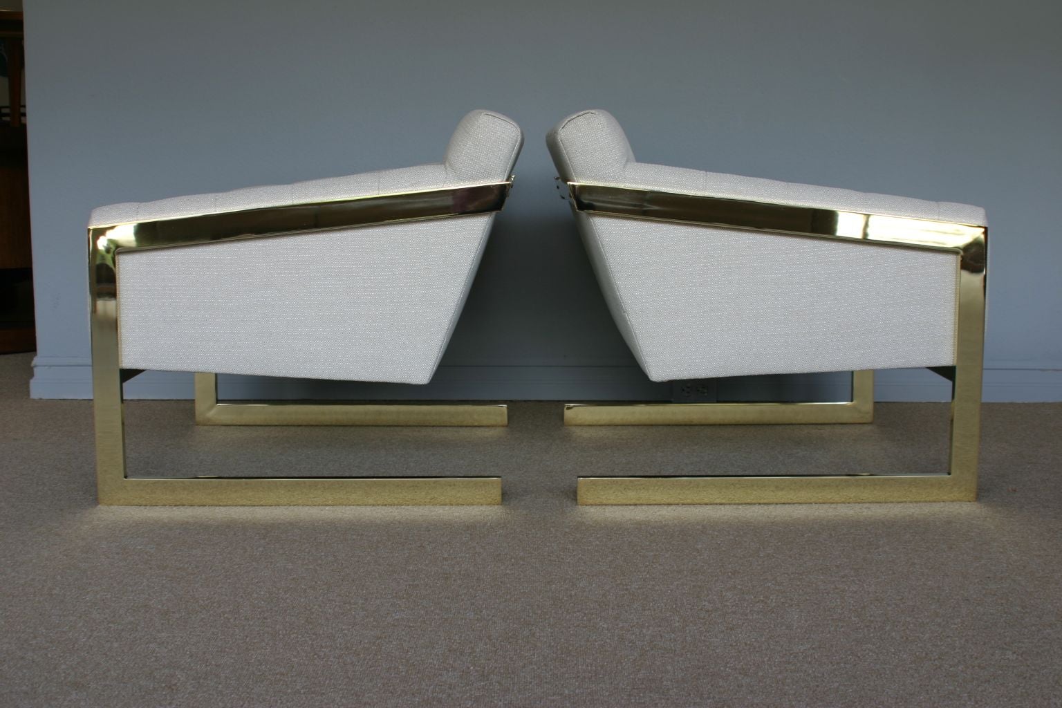 Pair of brass framed and tufted cantilevered lounge chairs by Milo Baughman