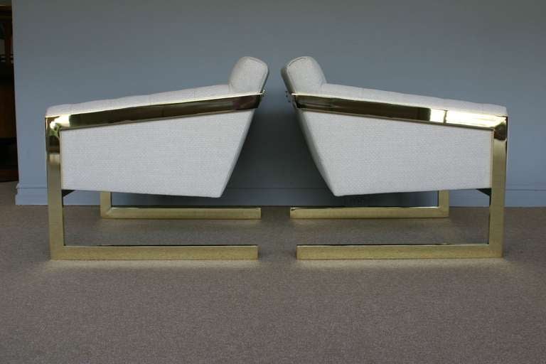 Pair of brass framed and tufted cantilevered lounge chairs by Milo Baughman for Thayer Coggin.  New high polished brass to the frames with new upholstery.  