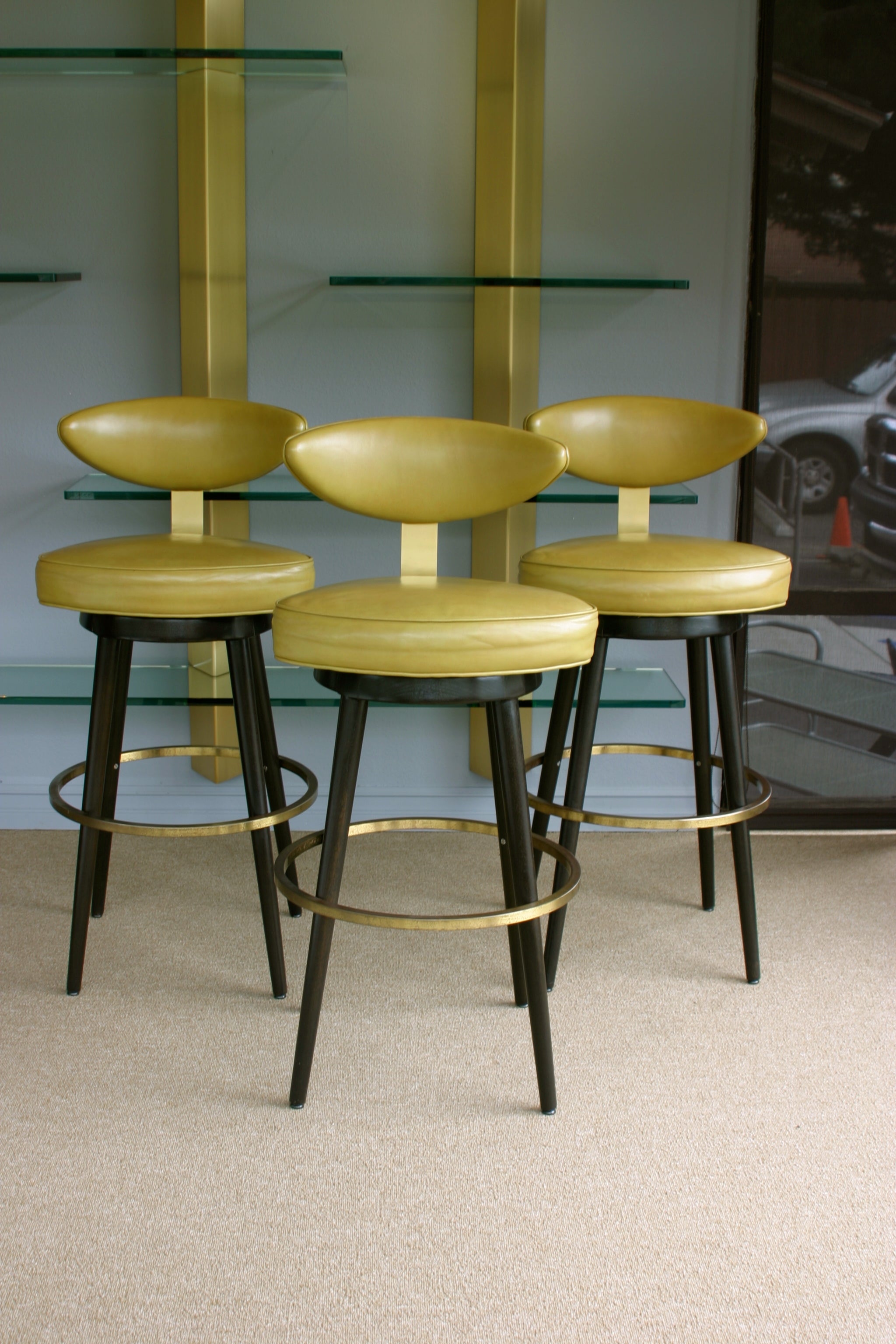 Set of three leather swivel barstools by Maurice Baily Of Monteverde Young
