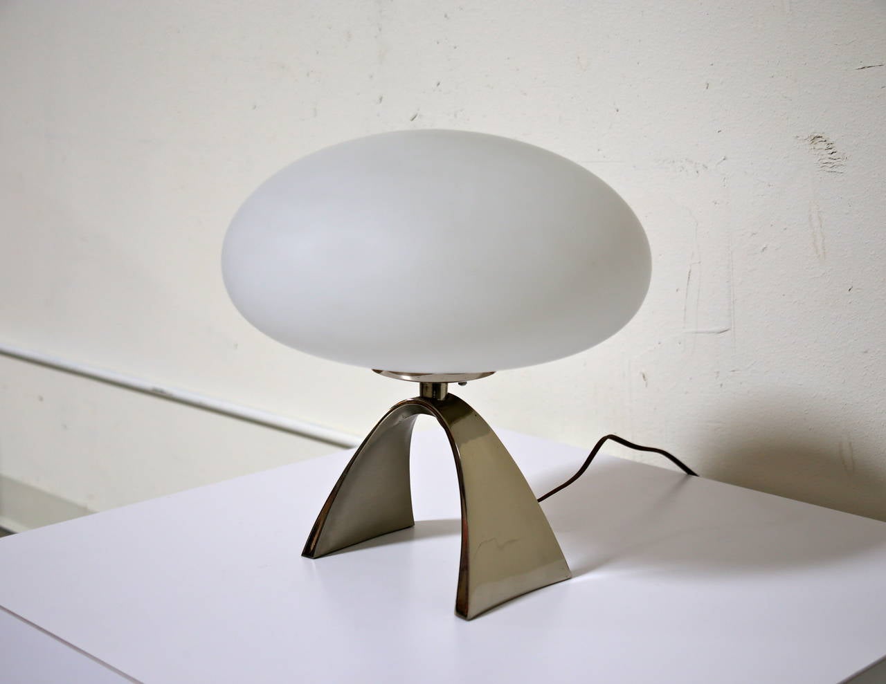 Frosted glass mushroom lamp by Laurel with arched polished nickel base.