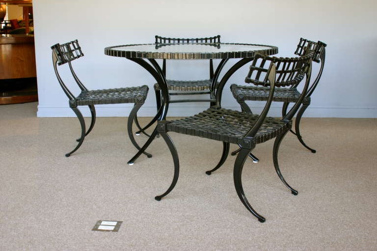 Thinline cast aluminum Klismos dining set. Table and four chairs. Table measures 44 3/4