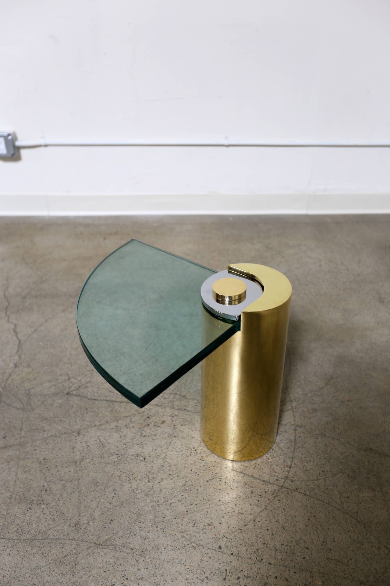 Polished brass, chrome and glass side table by Karl Springer.