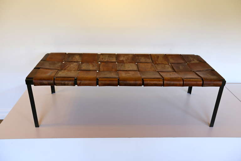 Woven leather and iron bench.