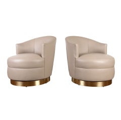 Pair of leather swivel club chairs by Karl Springer
