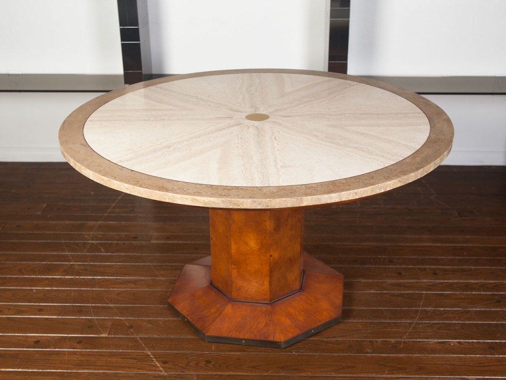 Game / dining table by JOHN WIDDICOMB.  Travertine top with brass detail rest on a burl wood pedestal base.