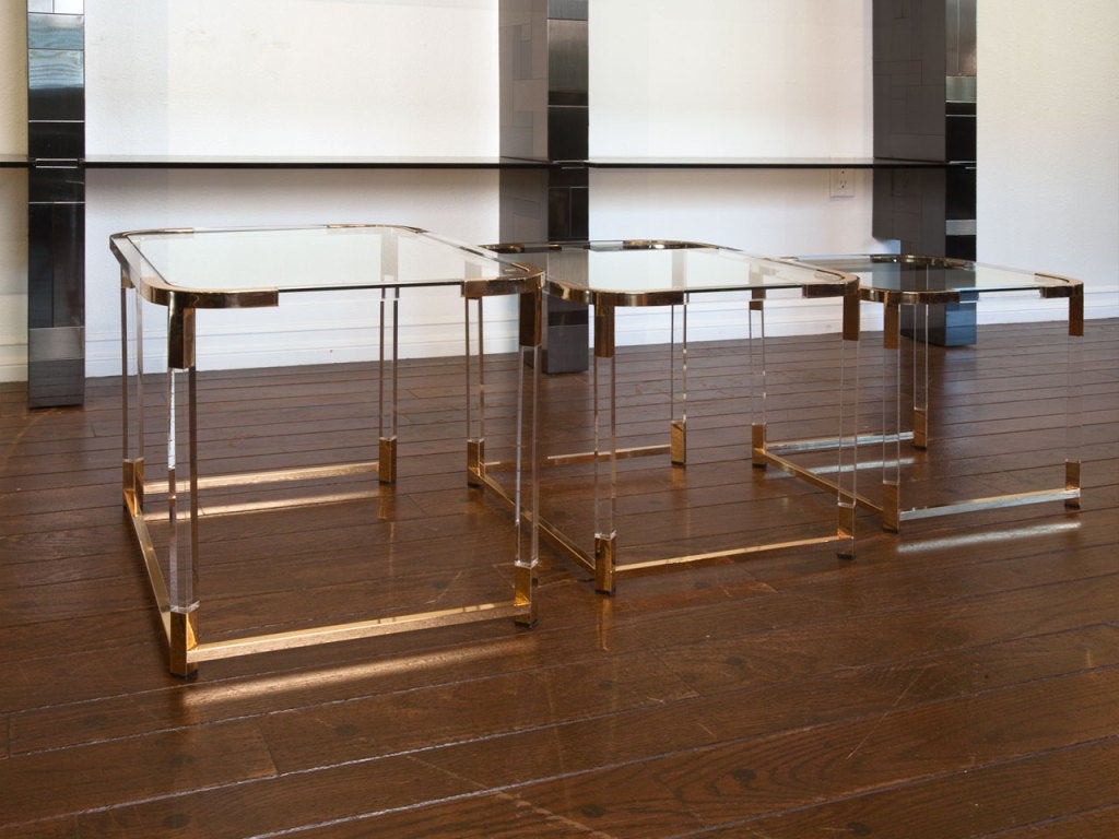 Set of lucite, brass and glass nesting tables by CHARLES HOLLIS JONES.