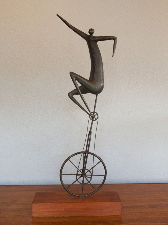 Tall bronze unicycle sculpture by Jack Boyd.