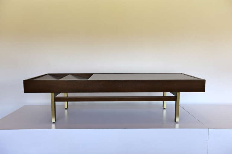 Walnut coffee table by Merton Gershun with multiple storage options.