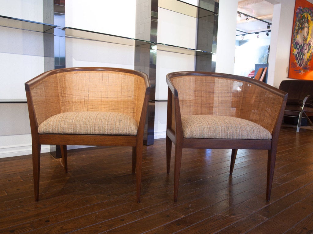 Pair of cane and walnut arm chairs by KIPP STEWART for DIRECTIONAL