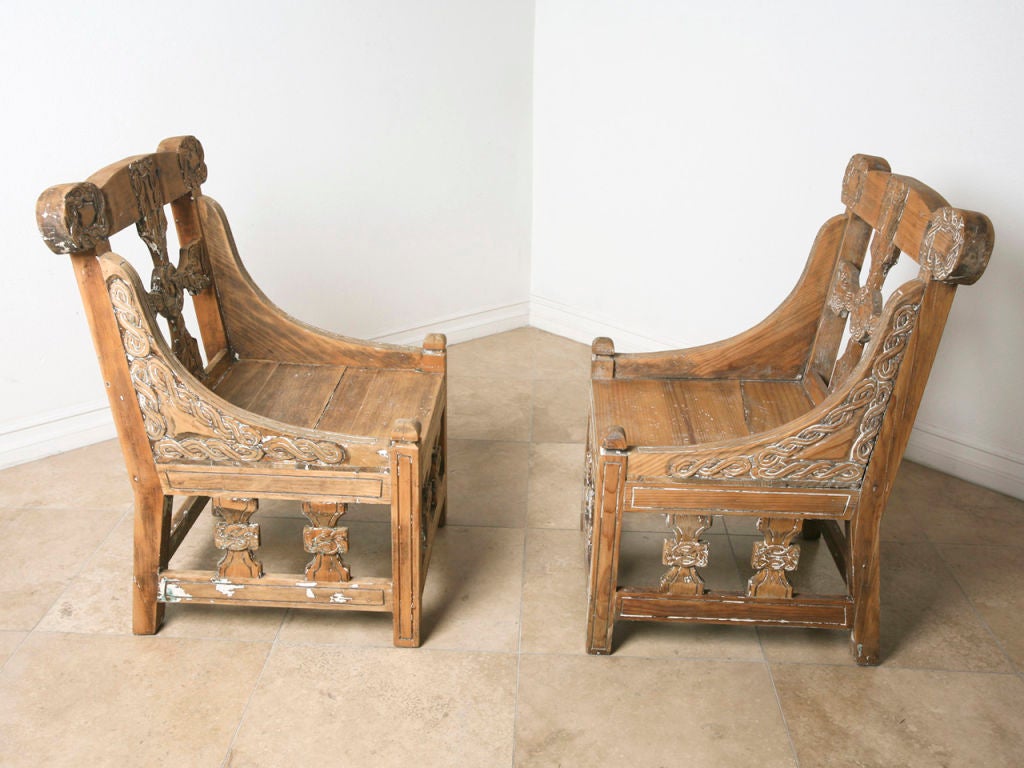 pair of 1860's pine Celtic slipper chairs.  Hand carved detail showing the Celtic cross and knot.  Beautiful Weathered patina.