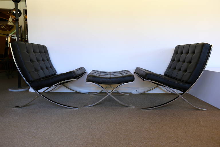 Pair of Barcelona Chairs w/ Ottoman by Mies van der Rohe 1972 Knoll Production.  Beautiful patina to the original leather.  Stainless steel frames.