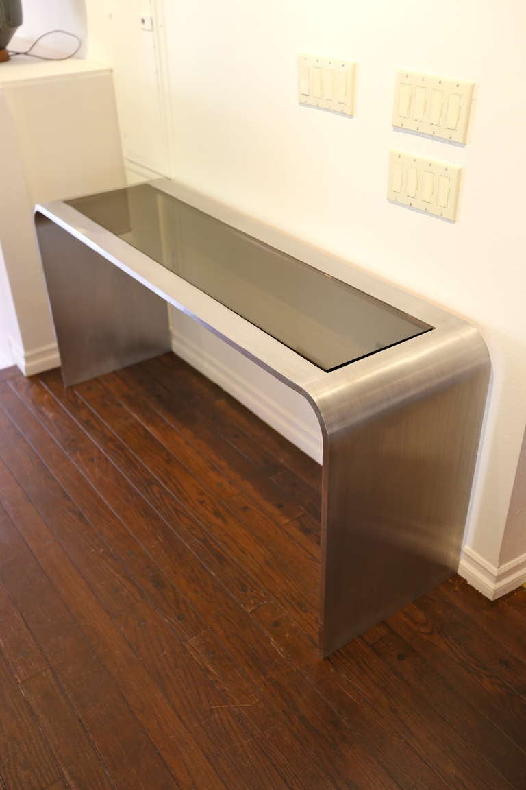 Brushed stainless steel console table by Leon Rosen.