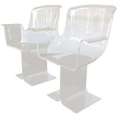 Pair of lucite swivel armchairs