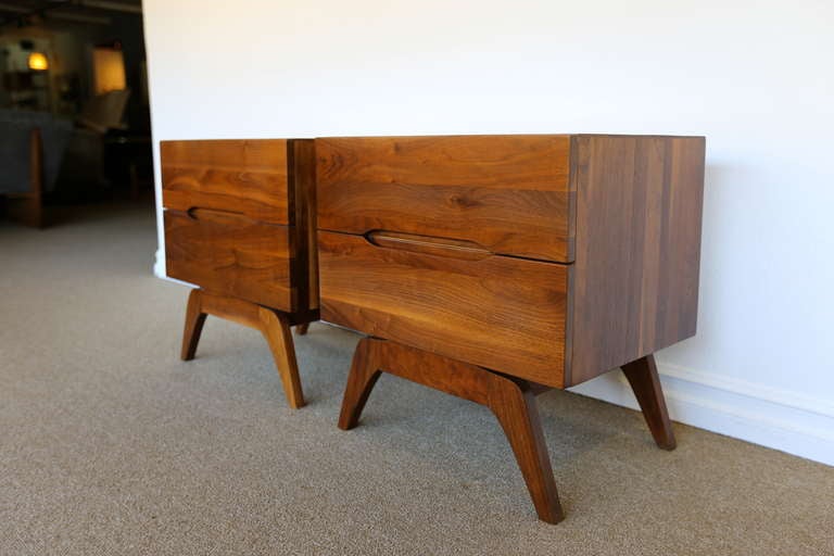 Pair of solid walnut nightstands with sculptural legs.