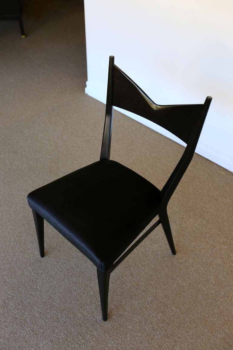 Six ebonized mahogany dining chairs by Paul McCobb for Calvin.  Sculptural design with a deep V back.
