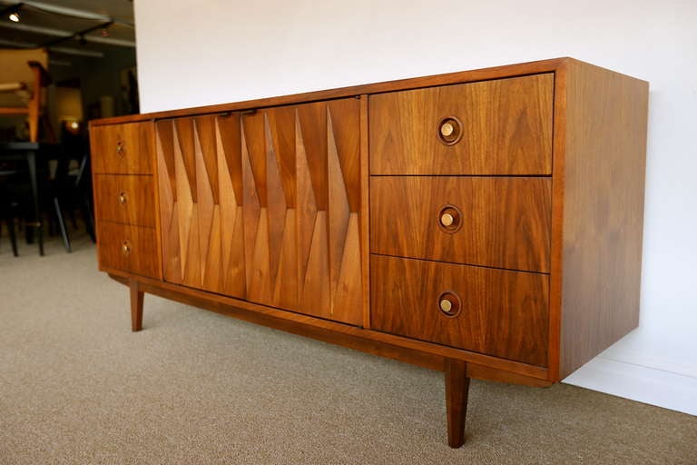 Sculptural walnut diamond front credenza dresser. Beautiful grain with a sculptural front. By American of Martinsville often attributed to Albert Parvin.