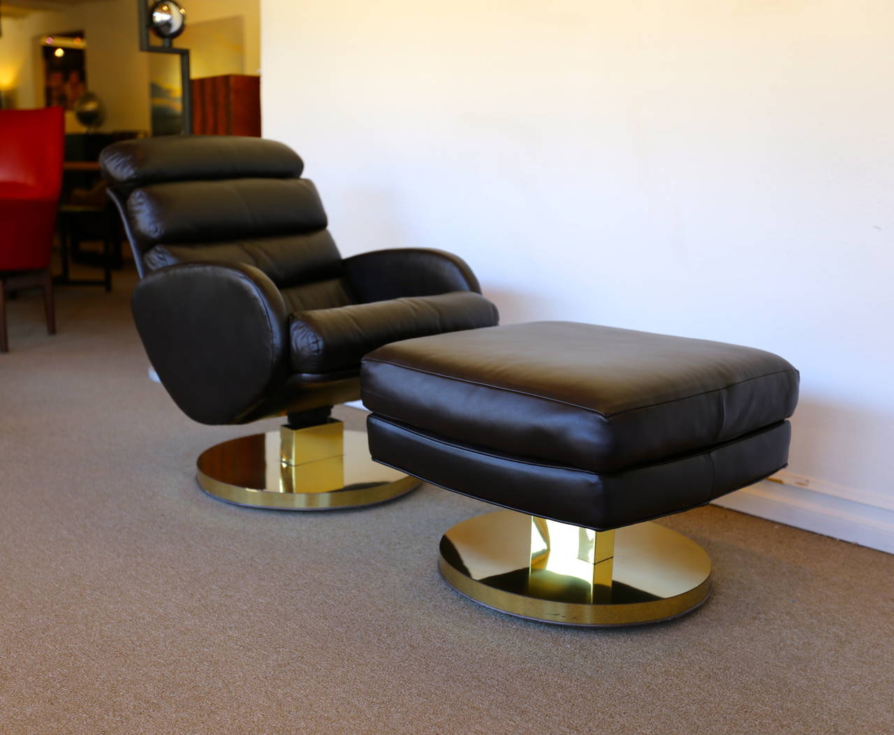 Leather and brass lounge chair and ottoman by Milo Baughman for Thayer Coggin. The lounge chair tilts and both the chair and ottoman swivel.