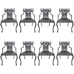 Set of eight Neoclassical cast iron arm chairs
