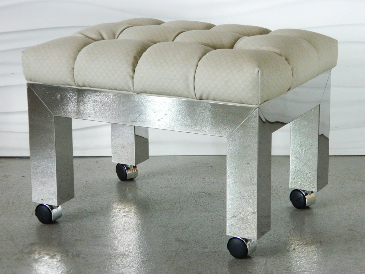 Designed by American designer Paul Evans for a custom dressing room, this chrome vanity stool has a tufted seat cushion and sits on casters.