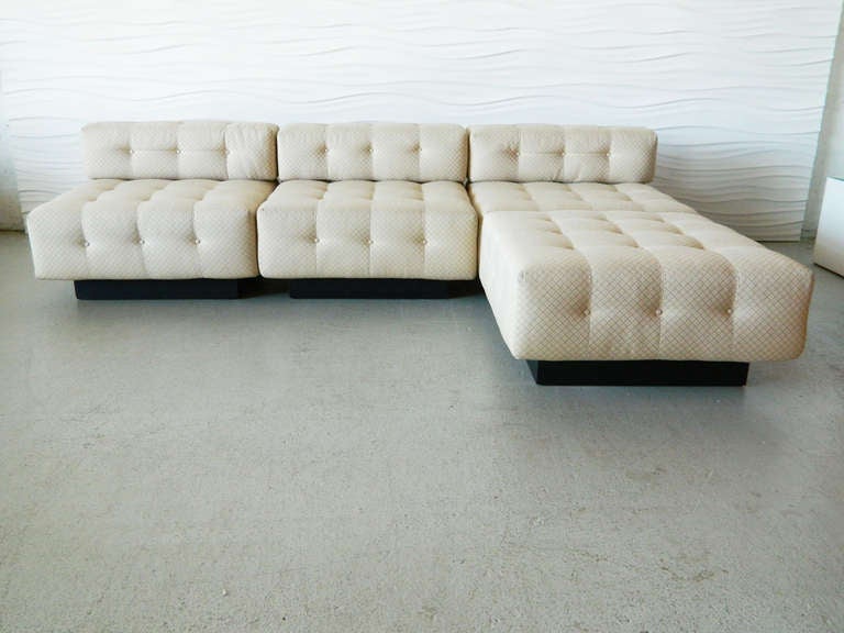 Attributed to American designer Harvey Probber, this tufted, modular sofa consists of three slipper chairs and one ottoman.