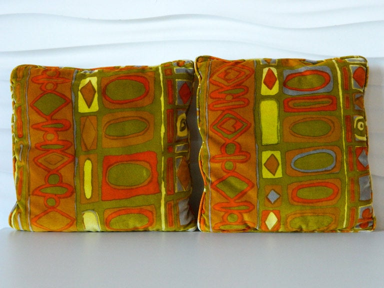 Oranges, yellows, purples and greens highlight this gorgeous pair of velvet pillows in Jack Lenor Larsen's Caravan print.
