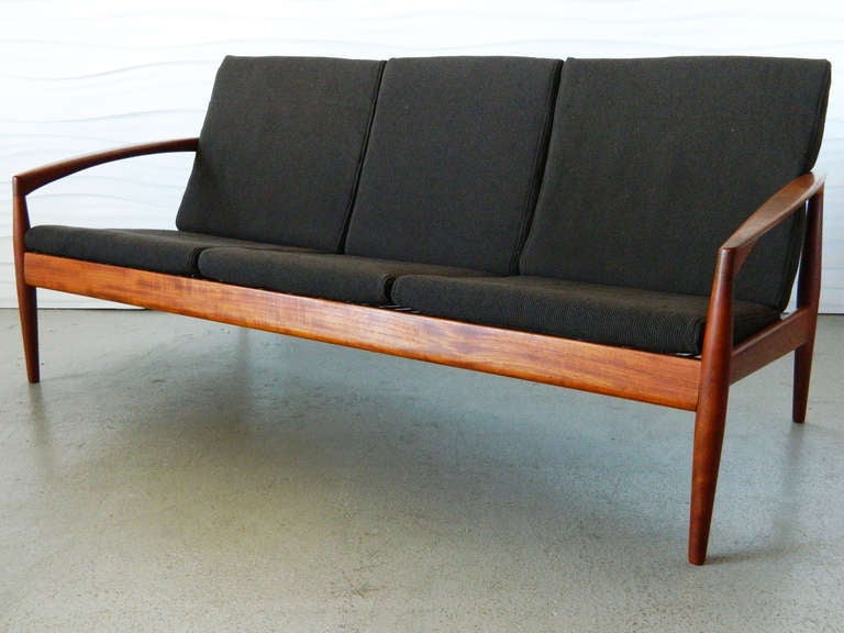 Designed by Danish designer Kai Kristiansen for Magnus Olesen in 1956, this three-cushion sofa was part of the 121 Series.