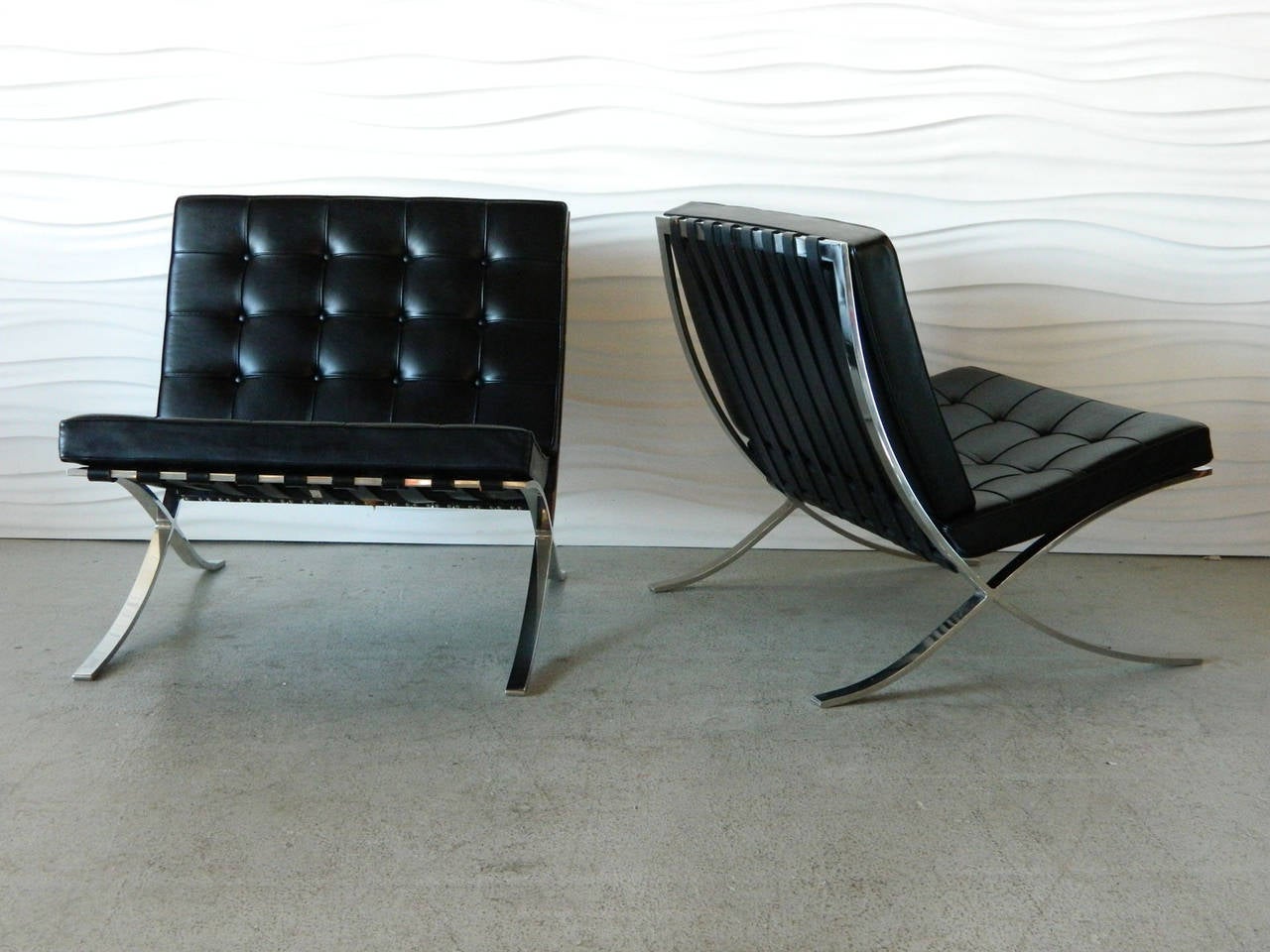 Designed by architect Ludwig Mies van der Rohe, this iconic pair of Barcelona chairs was manufactured by Knoll in the 1960s.