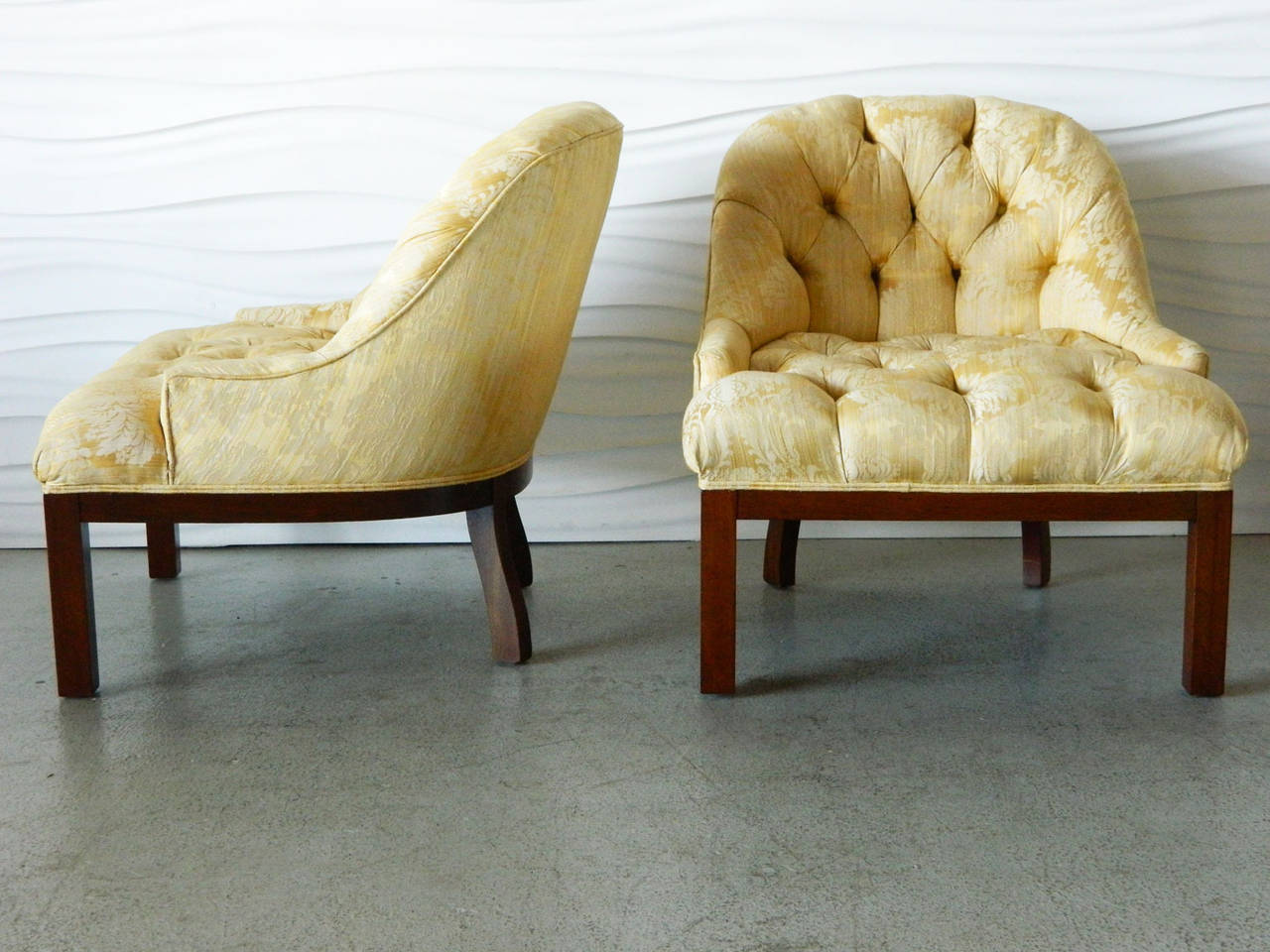 Handsome pair of American modern tufted slipper chairs with low armrests in the style of Edward Wormley.