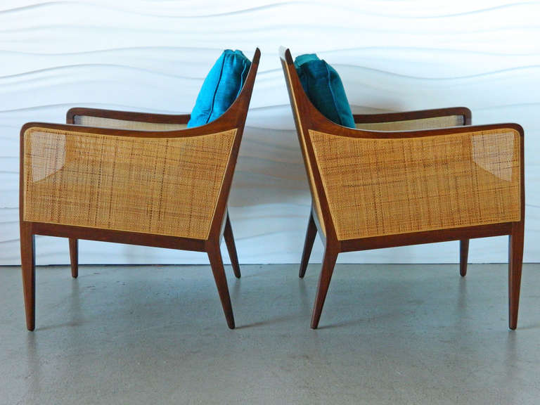 Handsome pair of Directional walnut chairs with caned backs and sides designed by Kipp Stewart.