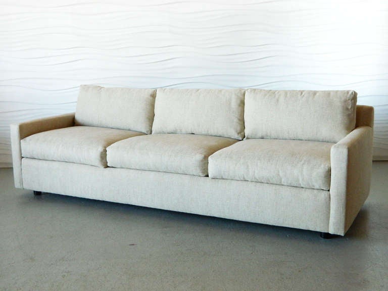 Low profile, three-seater Directional tuxedo sofa upholstered in cotton-linen fabric with a linen weave. Seat cushions and back cushions are foam-filled.