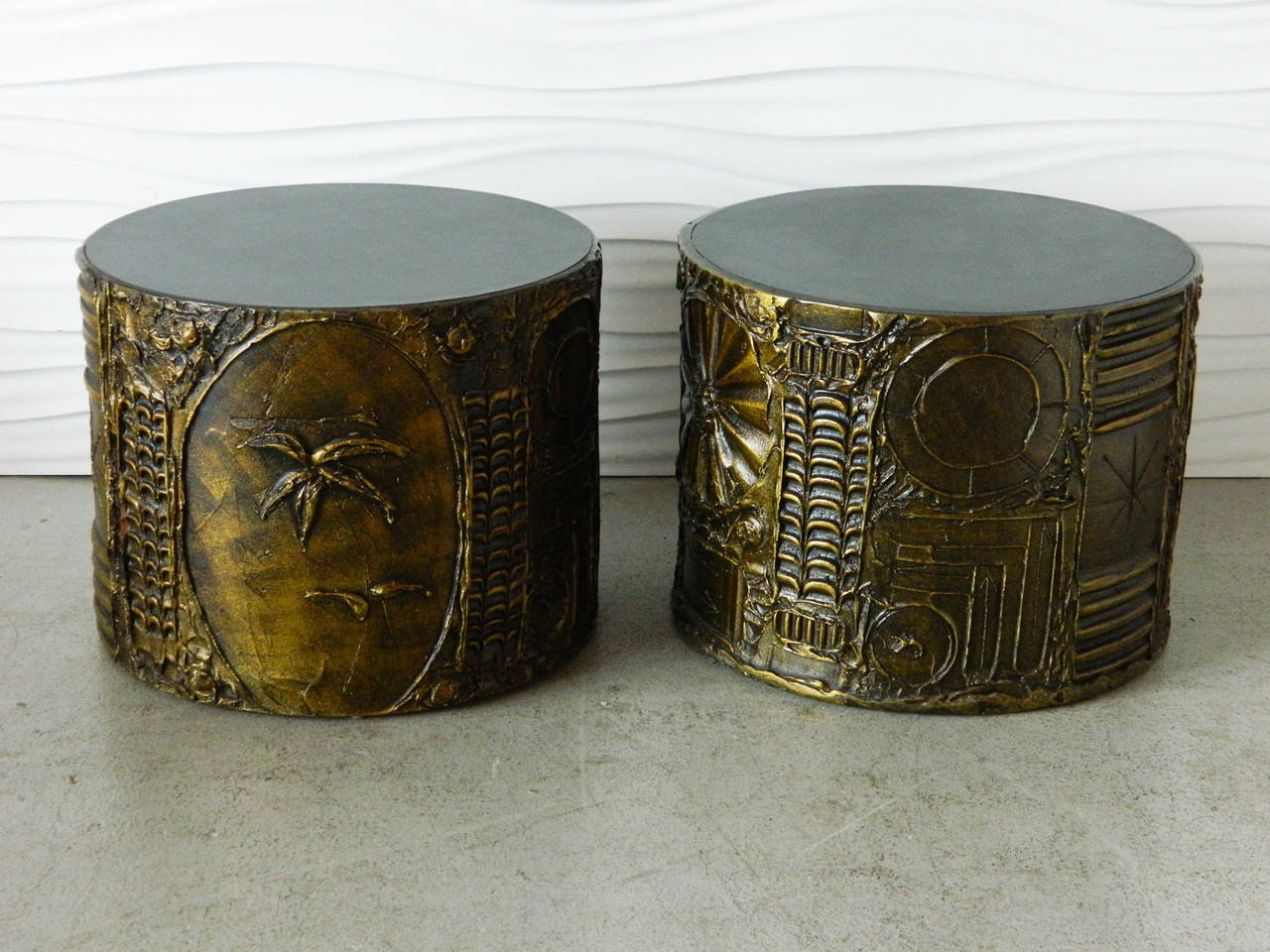 Paying homage to Paul Evans' sculpted bronze series, this pair of Brutalist drum tables by Adrian Pearsall features black laminate tops and nature motifs in a sculpted resin.