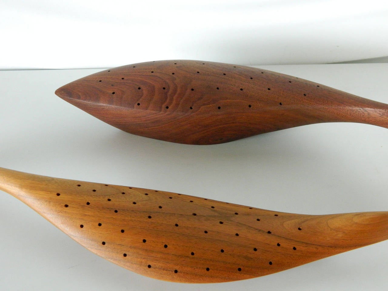 American-born Emil Milan (1922-1985) was a trained sculptor and woodworker. He created stunning bowls, plates and spoons as well as figural objects. These two canape holders in the shape of a bird and fish combine Milan's philosophy of combining the