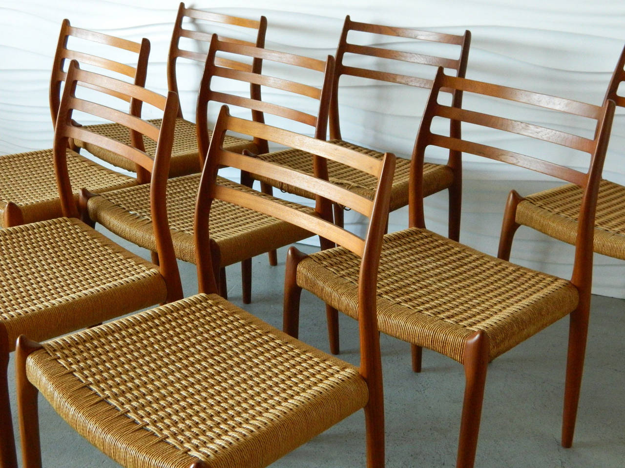 This set of Niels Møller Model No. 78 teak dining chairs consist of eight side chairs with their original papercord seats.