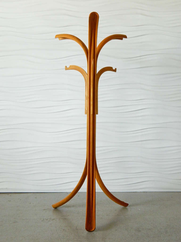 This solid teak bentwood coat stand has a splayed, fluted base and six branches.