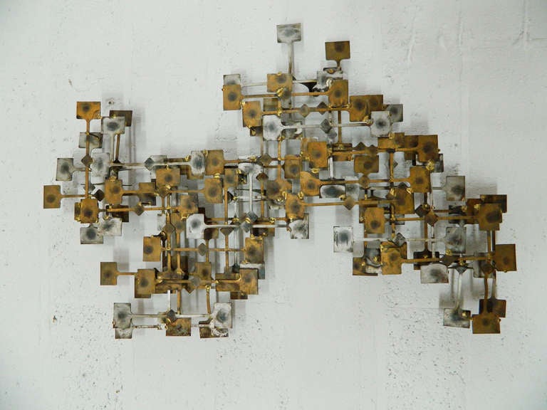 Similar in style to Curtis Jere, this multi-dimensional wall sculpture by St. Louis, Missouri artist Mark Weinstein features soldered metal squares in an abstract grid pattern. Labeled Marc Creates.