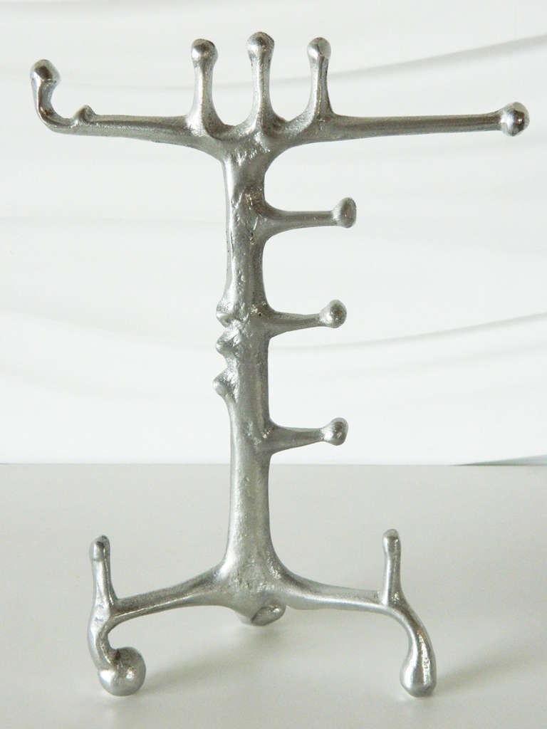 This cast aluminum stand in the style of Donald Drumm is perfect for displaying favorite pieces of jewelry.