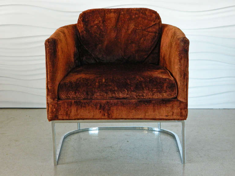 This chrome base barrel chair from the 1970s is in the style of Milo Baughman.