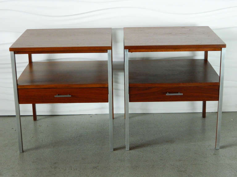 This handsome pair of walnut nightstands with aluminum pulls and trim was designed by American designer Paul McCobb for Calvin Furniture.