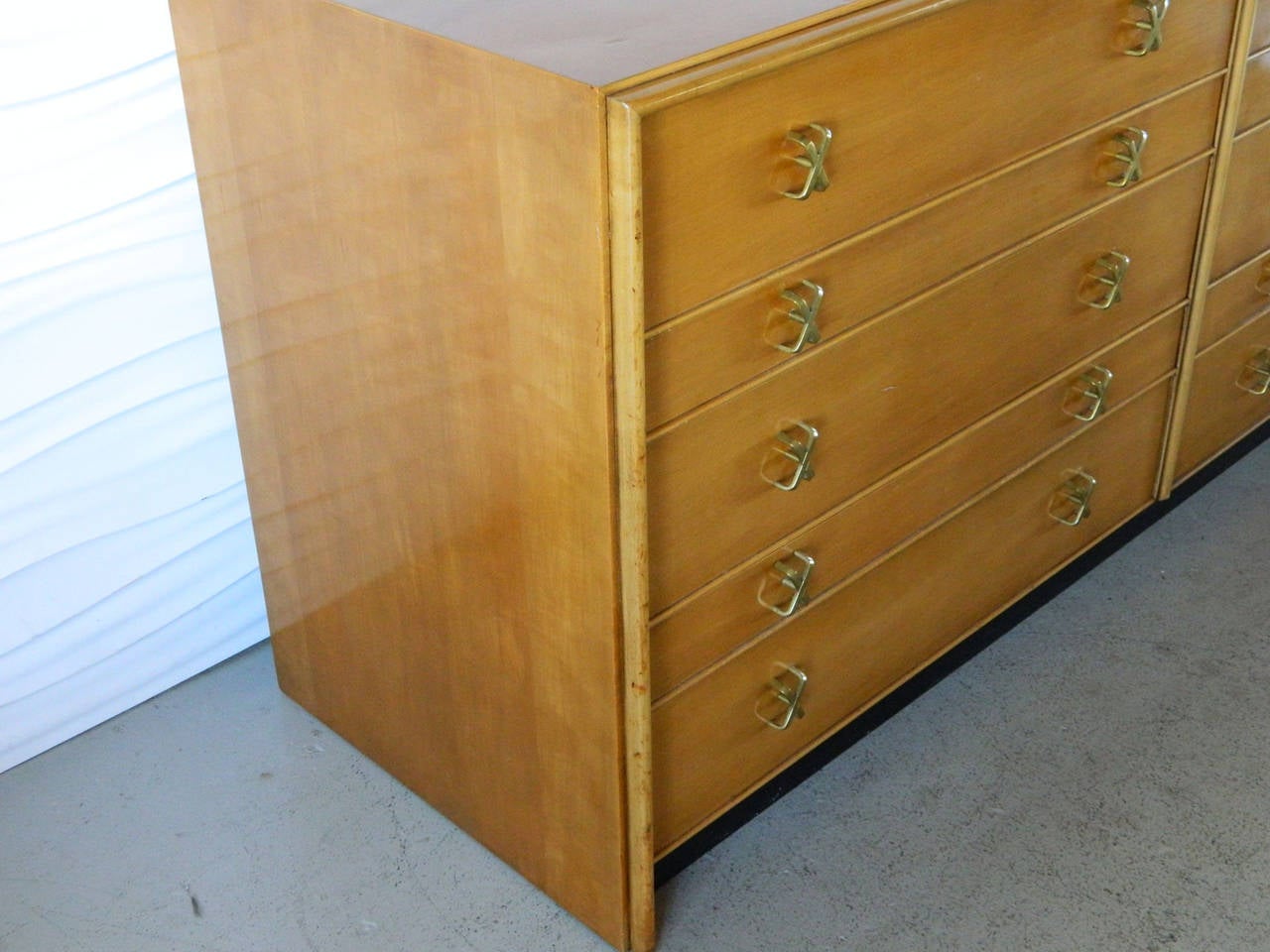 This ten-drawer dresser by American designer Paul Frankl for John Stuart was manufactured in the 1950s. It is made of maple and has Frankl's trademark X pulls.